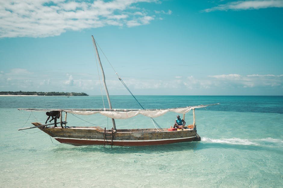 Deux pecheurs sur un dhow traditionnel dans les eaux de Zanzibar